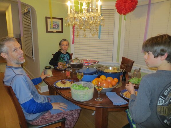 img_5013 Dinner time. Looks like Martin has managed to stay in his pajamas all day. I spy a yummy chocolate cake.
