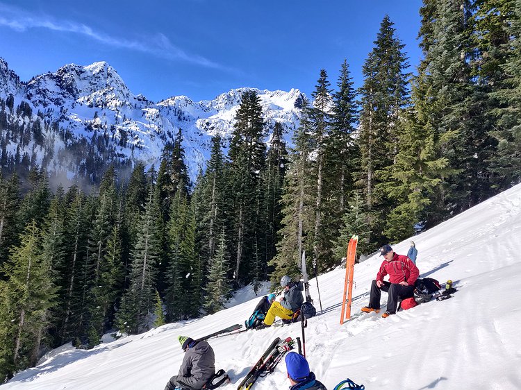 2021-01-18 12.16.14 Lunch time chilling on a slope on the opposite side of the valley from Alpental's backcountry prior to digging test pits.