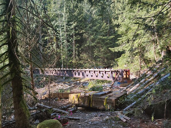 2022-10-06 11.36.52 A brand new bridge going in which is kind of crazy since the trail is rarely used. These two huge steel beams were brought in by helicopter during the couple...