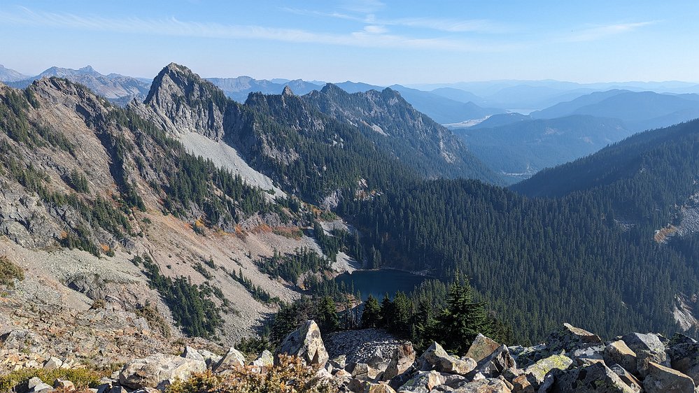 2024-10-13 15.13.05 Looking way down at Lower Lake Melakwa. We're now reaching the elevation of the peaks looming over the Alpental valley - Hemlock Peak, Bryant Peak, The Tooth,...